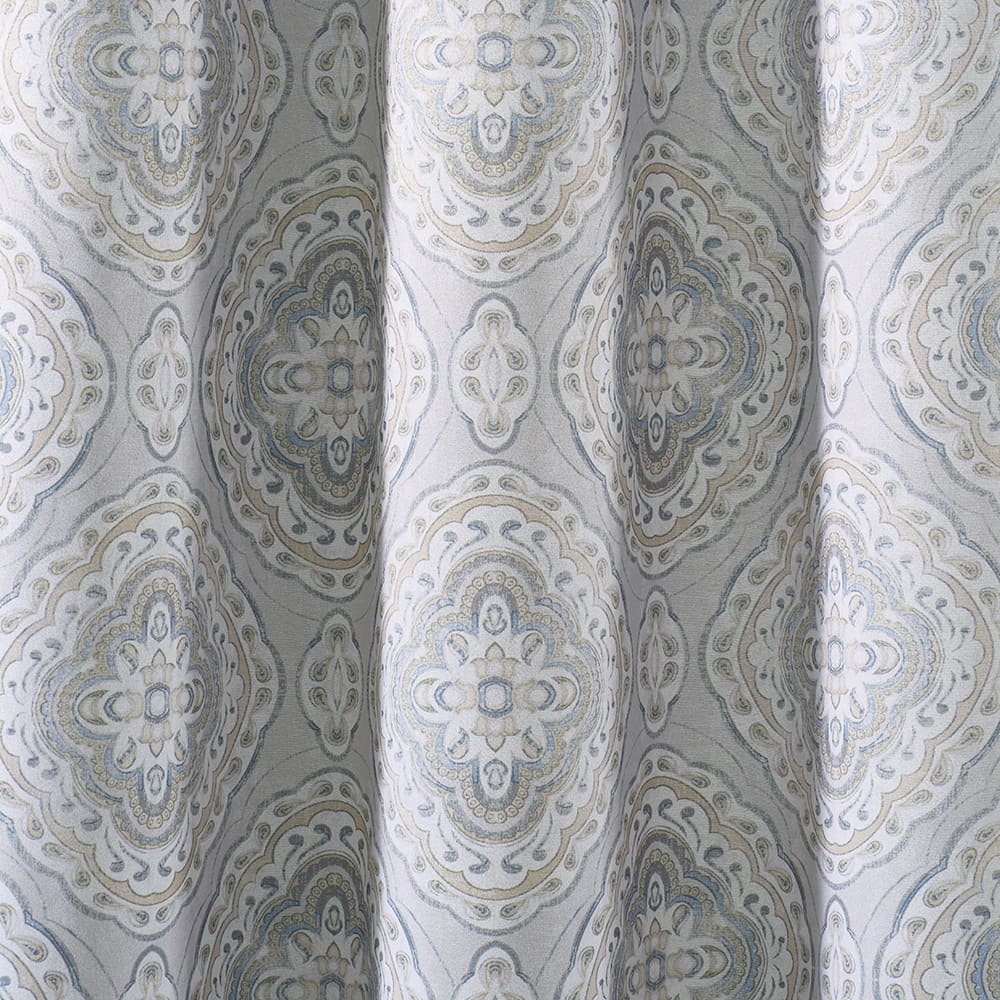 The folds of a Camilla blue panel, close up
