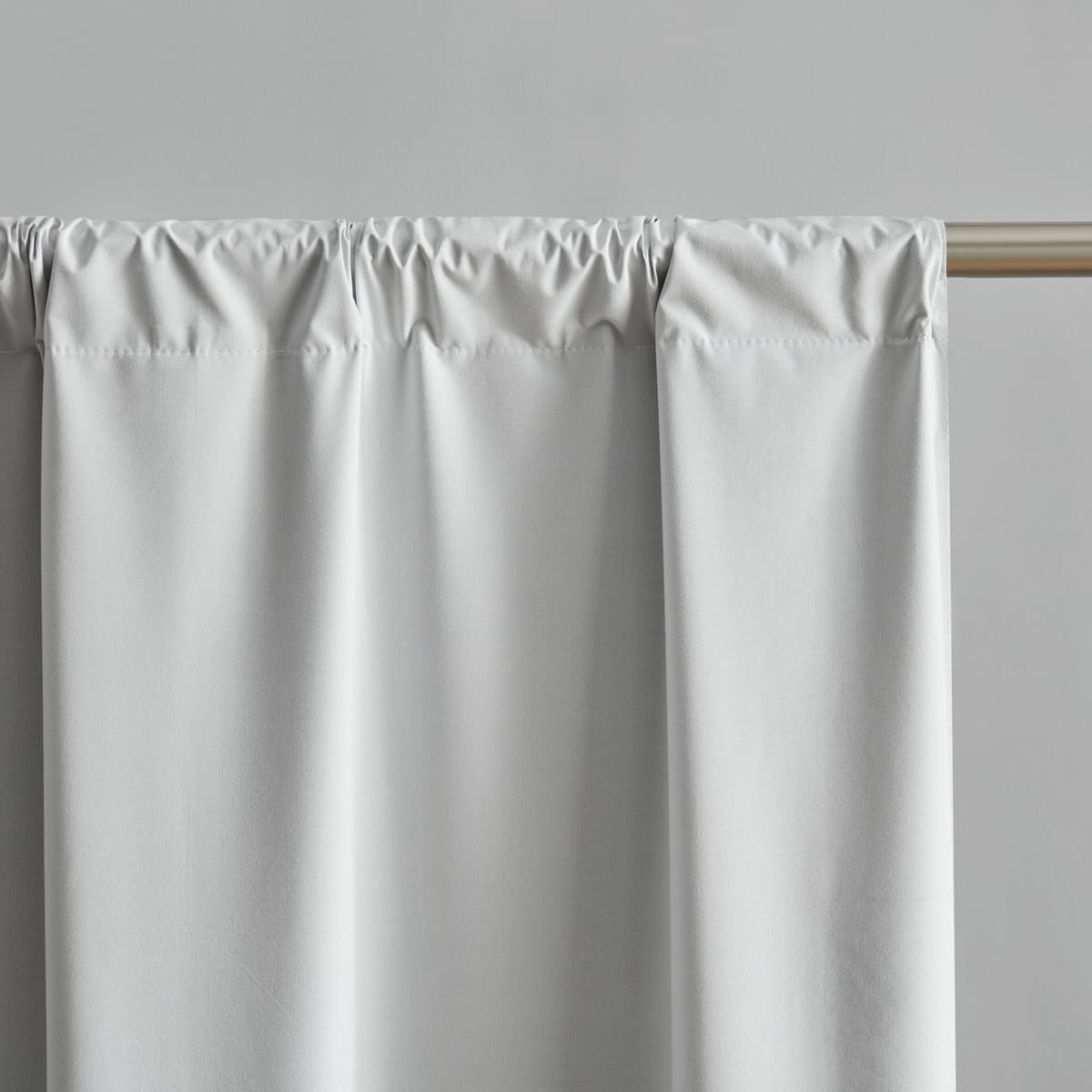 The top of a white panel gathered on a rod through its rod pocket