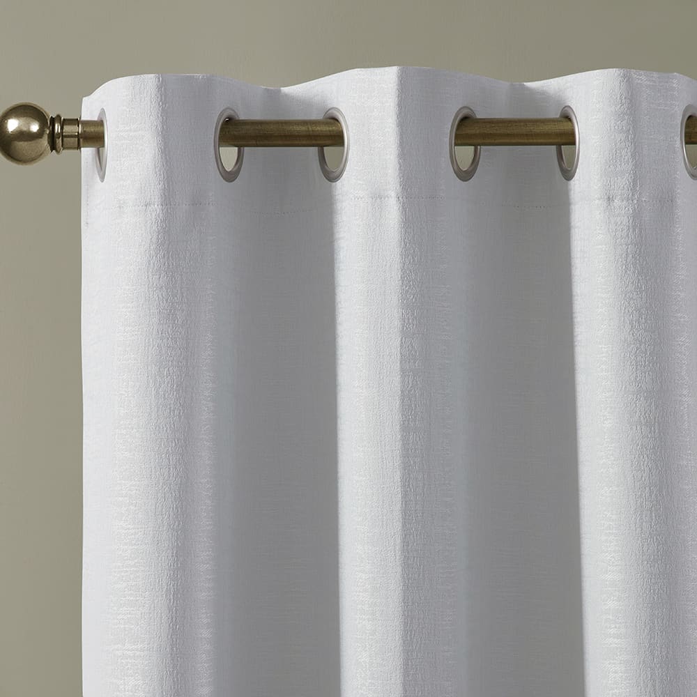 Close-up of the metal grommets along the top of a white Paloma panel on a rod