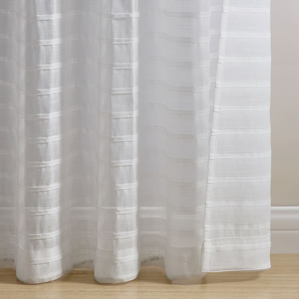 The bottom of a Pleated Stripe white panel where it meets the floor