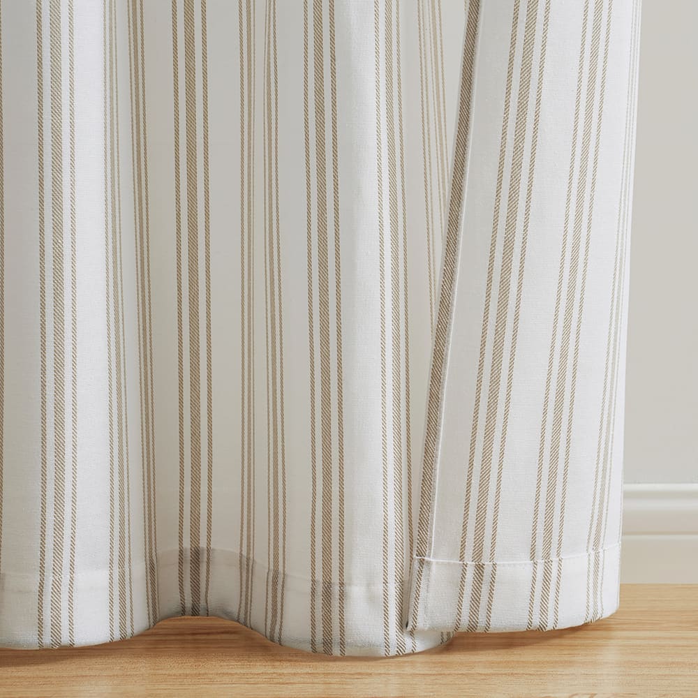 The bottom of a Ticking Stripe stripe panel where it meets the floor
